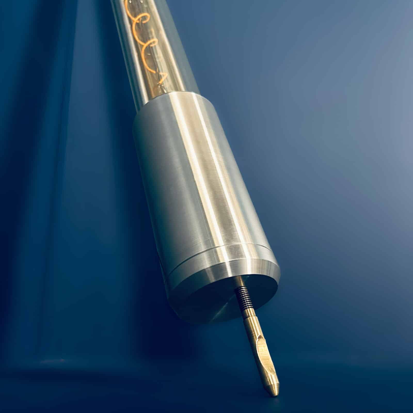 Industrial style tube floor lamp made from machined aluminium and glass and fitted with two edison LED filament tubes - making this design fuse both form and function. It is a leaning tube floor lamp which elegantly stands on a point to illuminate corners and walls from the floor.